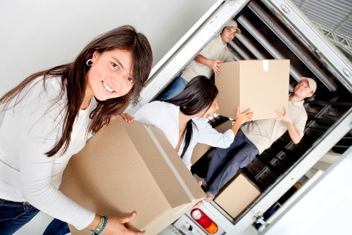 Removal van loading furniture from a Sydenham flat with stair access
